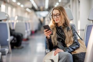 Woman looking at Phone on the Bus